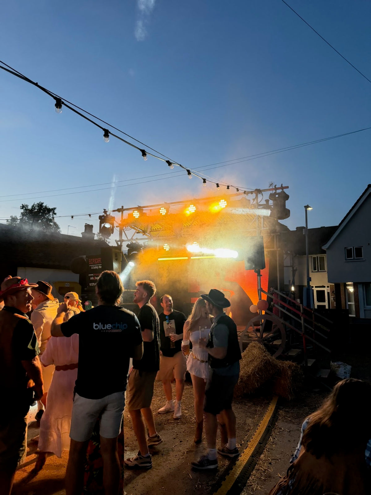 Stage lighting beams and haze at dusk at a Wild West themed party in Diss